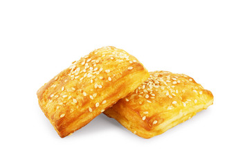 Buns sprinkled with sesame seeds on a white background