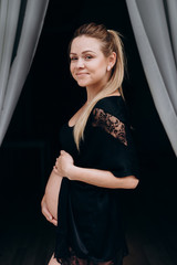 Smiling pregnant woman posing in studio