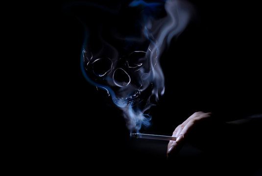 Skull from cigarette smoke. Smoke formed skull dead, as symbol of dangers of smoking to health. The concept smoking kills on black background