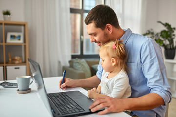 multi-tasking, freelance and fatherhood concept - working father with baby daughter and laptop computer at home office