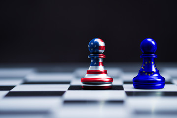 USA flag and EU flag print screen on two  pawn chess for battle.It is symbol of United States of America increase tariff tax barrier for import product from EU countries.-Image. © Dilok