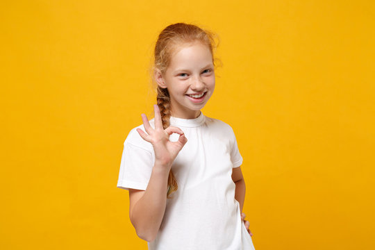 Little baby girl in white blank white t-shirt design red head band happy  smiling on yellow Stock Photo