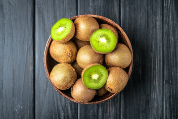 Ripe fresh kiwi fruits  on dark background. Top view with  copy space.