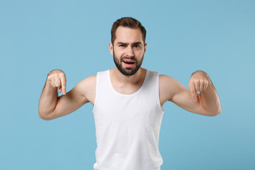 Naklejka premium Happy bearded young man 20s years old perfect skin wearing white shirt isolated on blue pastel wall background, studio portrait. Skin care healthcare cosmetic procedures concept. Mock up copy space.