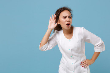 African american doctor woman isolated on blue background. Female doctor in white medical gown...
