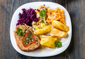 tasty homemade dinner - meat, baked potatoes and a set of salads