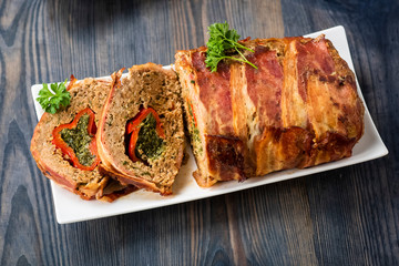 baked roulade of minced meat surrounded by bacon