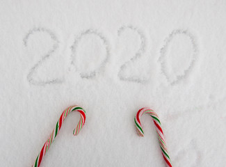 2020 figures painted on the snow with Christmas candy 
