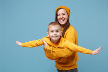 Woman in yellow clothes have fun posing with cute child baby boy 4-5 years old. Mommy little kid...