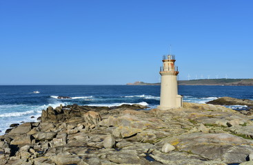 Famous Muxia Lighthouse located at Camino de Santiago pilgrimage with blue sky. Spain.