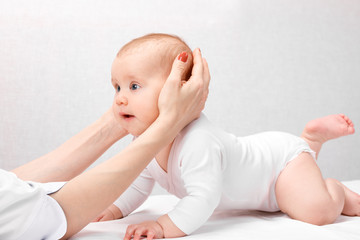 Little baby receiving osteopathic treatment of head and neck