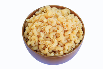 Elbow macaroni in brown bowl on a white background.
