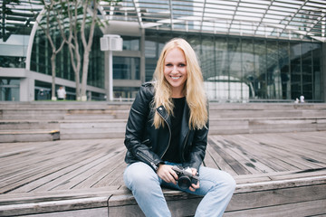 Young photographer resting on wooden stairs