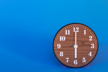 The clock at six o'clock in the blue background