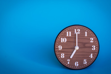 The clock at seven o'clock in the blue background