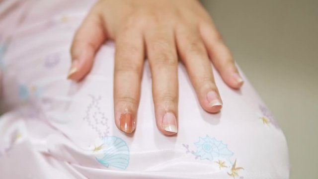 Closeup of a woman paints her nails by self made manicure at home slow motion scene. 4K 25fps