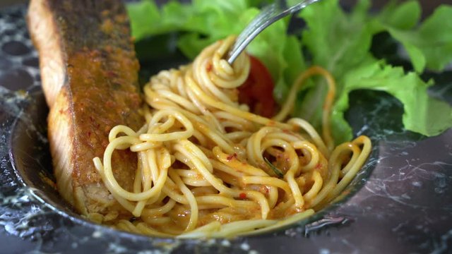 spaghetti with fried fish fillet and spicy sauce