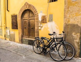 Fototapeta na wymiar Retro Style Photo with Bicycle Against Old Italian Building