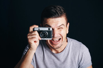 guy with an old camera, cheerful smile at you - 309990842