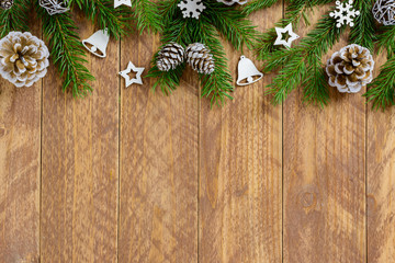 Christmas decorations, pine cones and stars on a white wooden table. Top view, copy space.