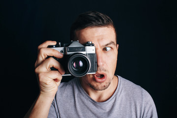 guy with an old camera, cheerful smile at you