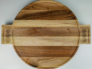 Beautiful traditional hand made wooden cutting board or pizza board made of natural wood with...