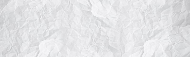 wide panorama white and gray crumpled paper texture background. crush paper so that it becomes...