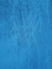 close-up of a decorative wall, with bokeh effect and characteristic rough porous texture, abstract dark and light stains