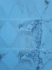 close-up of a decorative wall, with bokeh effect and characteristic rough porous texture, abstract dark and light stains