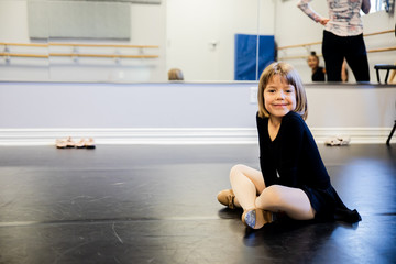 Young Girl sitting on floor in ballet studio