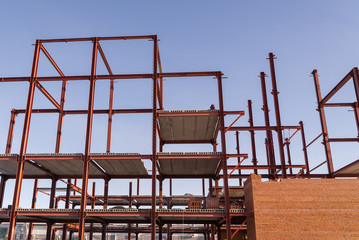 construction of the building of metal structures, metal frame roof. Steel design for the construction of the building against the sky.