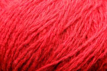 Wool yarn close-up colorful red thread for needlework in macro.