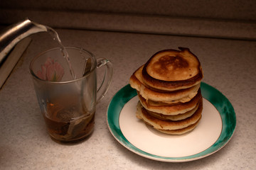 cup of tea and pancakes table