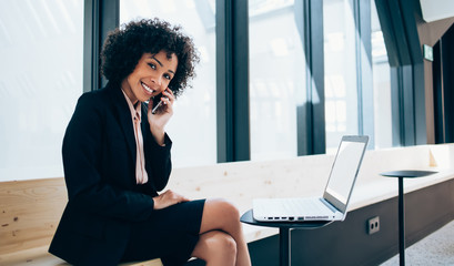 Portrait of cheerful smiling finance director in elegant wear enjoying communication with business...
