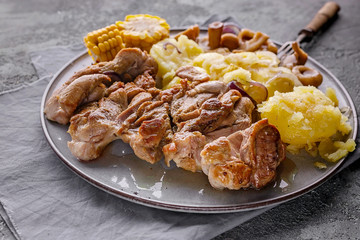 Chicken meat baked with potatoes, corn and pickled mushrooms. White diet meat. Close-up