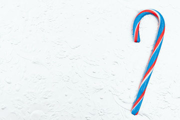 Red, white and blue candy cane on a silver background