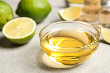 Lime essential oil in bowl on light table