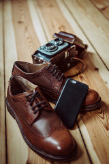Vintage analogue camera and brown shoes