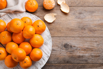 Fresh ripe tangerines on wooden table, flat lay. Space for text
