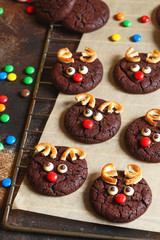 Reindeer cookies with candy red nose on a baking paper. Christmas concept.