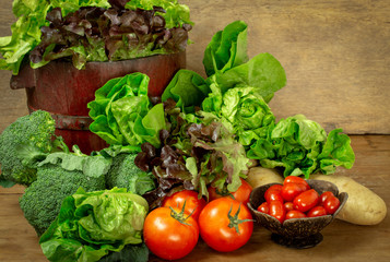 Selected fresh vegetables for salad on wooden table. Healthy eating and diet food.
