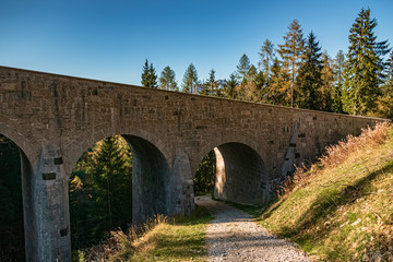 Fototapeta na wymiar Beautiful alpine autumn or indian summer view with an old stone bridge at the famous Rossfeldstrasse, Berchtesgaden, Bavaria, Germany