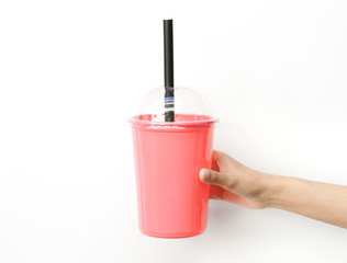 Holding a plastic cup with a plastic straw on a white background,stop the plastic straw and secure environment concept
