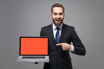 Excited business man in suit shirt tie posing isolated on grey background. Achievement career...