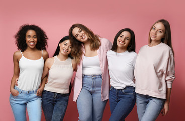 Group of women with different body types on pink background