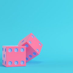 Pink two dices on bright blue background in pastel colors