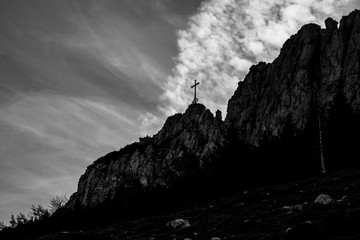 Beautiful alpine black and white view with the summit cross of the famous Kampenwand, Aschau im Chiemgau, Bavaria, Germany
