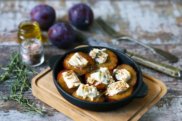 Baked plums with white cheese. Vegetarian snack. Selective focus. Macro.