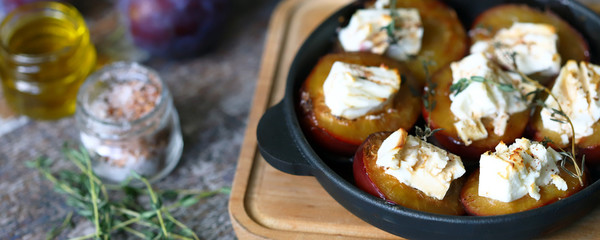 Baked plums with white cheese. Vegetarian snack. Selective focus. Macro.