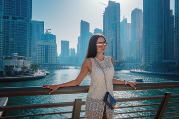Fototapeta na wymiar Happy beautiful tourist woman in Dubai marina